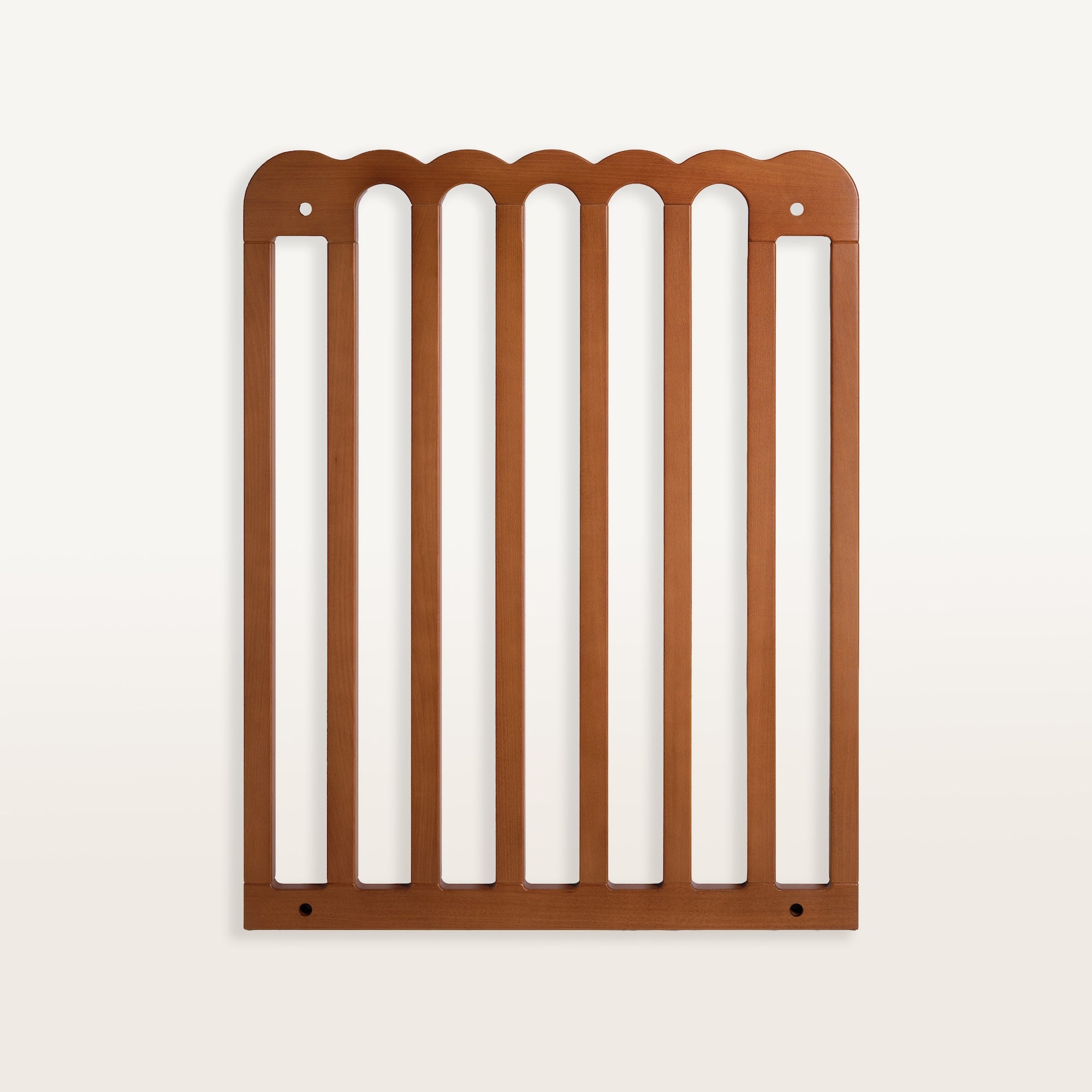 Walnut scalloped pet gate on a white background